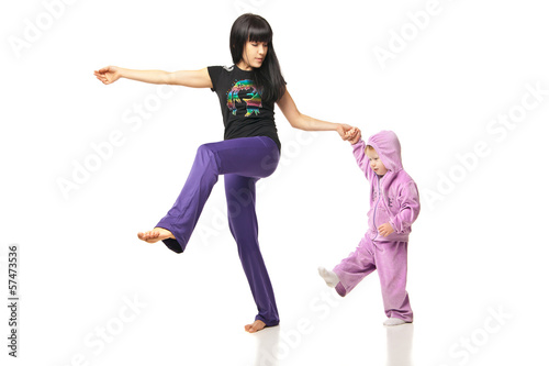 Mother with the baby doing exercises over white