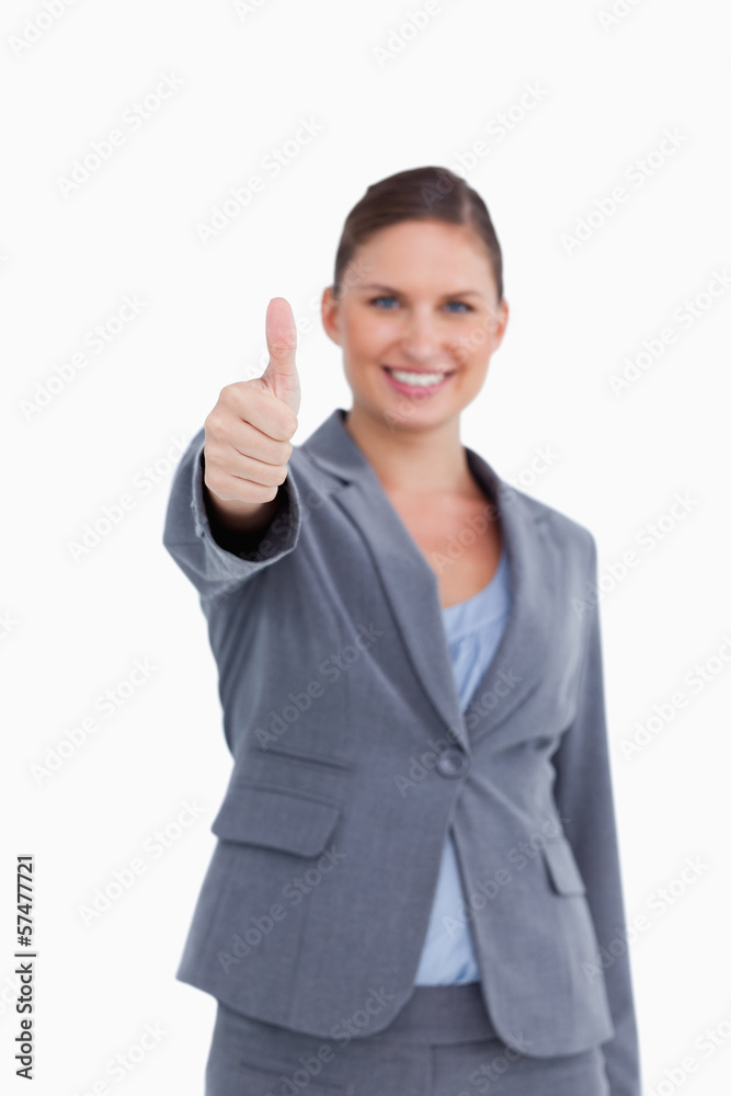 Thumb up given by smiling saleswoman Thumb up given by smiling saleswoman