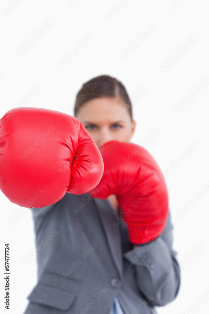 Attacking fist of tradeswoman in boxing glove Attacking fist of tradeswoman in boxing glove