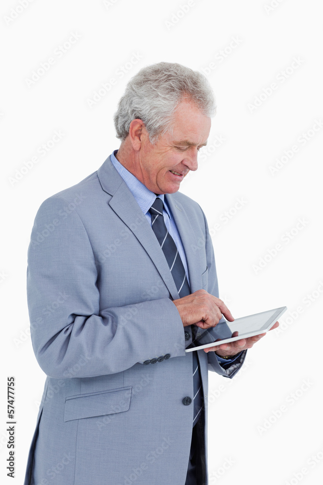Side view of smiling mature tradesman using tablet computer Side view of smiling mature tradesman using tablet computer