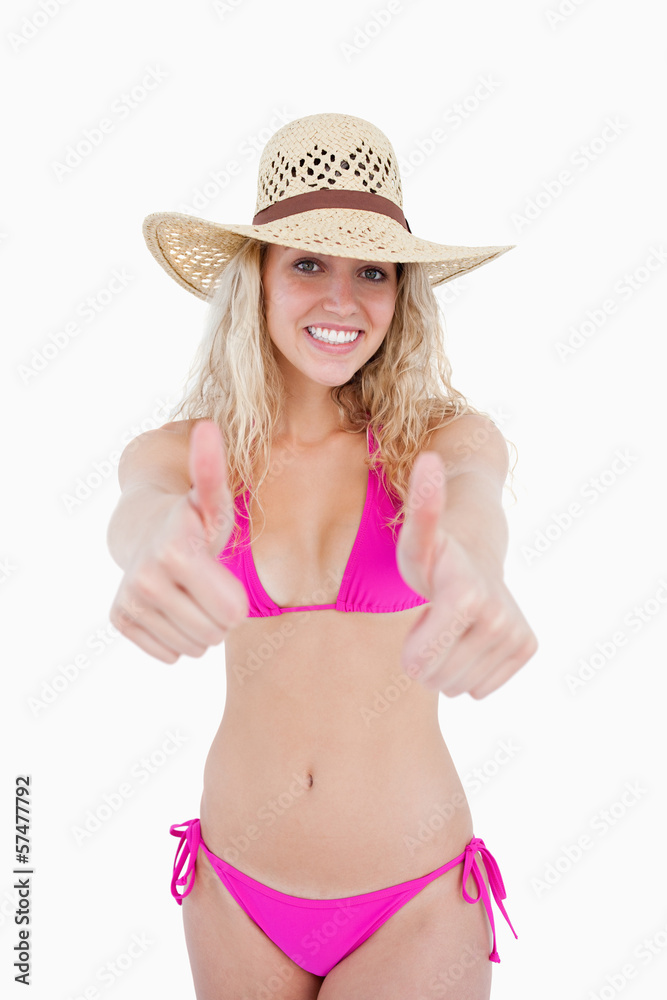 Attractive teenager showing a great smile with her thumbs up Attractive teenager showing a great smile with her thumbs up