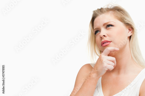 Attractive blonde woman lost in thoughts