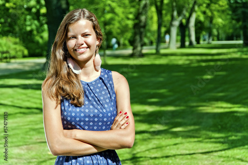 beautiful young brunette woman outdoor on the meadow on a summer