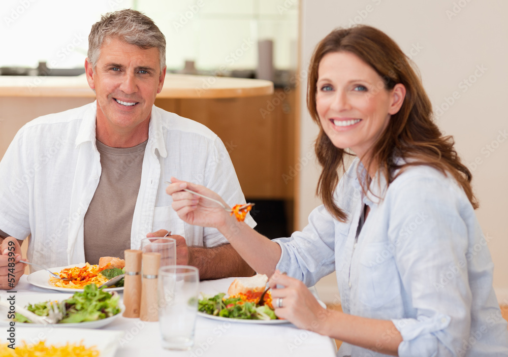Smiling couple eating dinner Smiling couple eating dinner