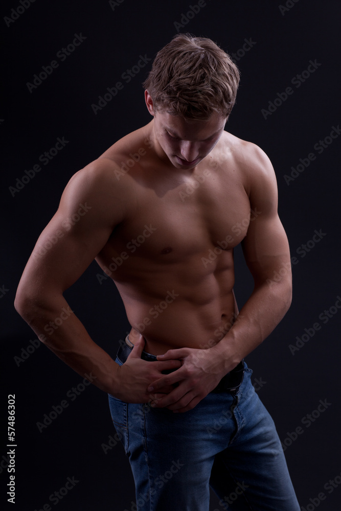 Muscle sexy naked young man posing in jeans Muscle sexy naked young man posing in jeans