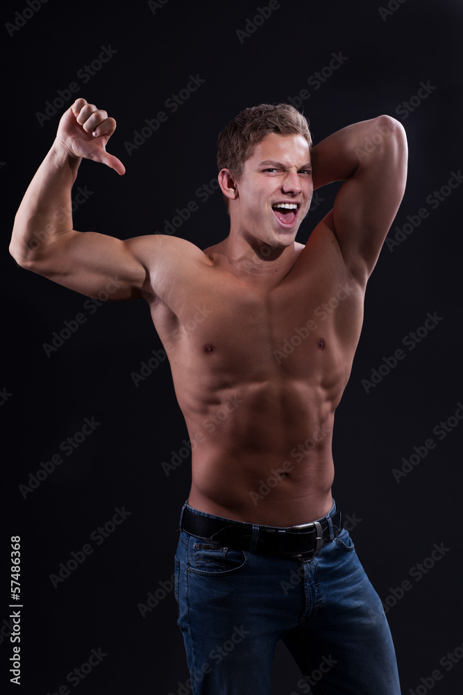 Muscle sexy naked young man posing in jeans