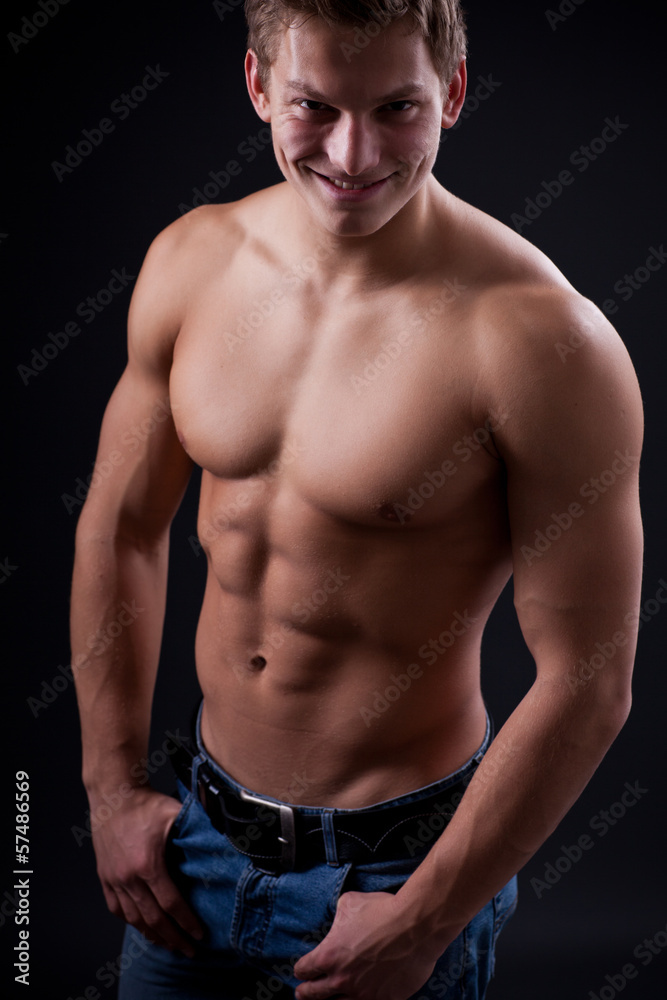 Fototapeta premium Muscle sexy naked young man posing in jeans