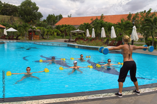 Aqua Gym: aerobics / fitness instructor in front of a group