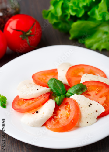 Tomato and mozzarella with basil leaves