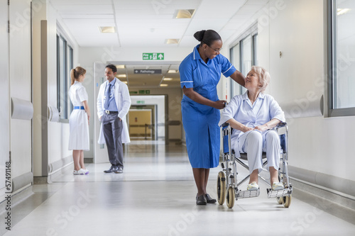 Senior Female Patient in Wheelchair & Nurse in Hospital photo
