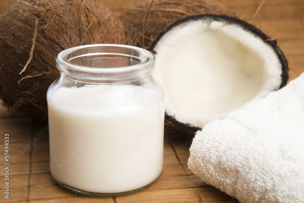coconut fruit with a jar filled with coco milk coconut fruit with a jar filled with coco milk