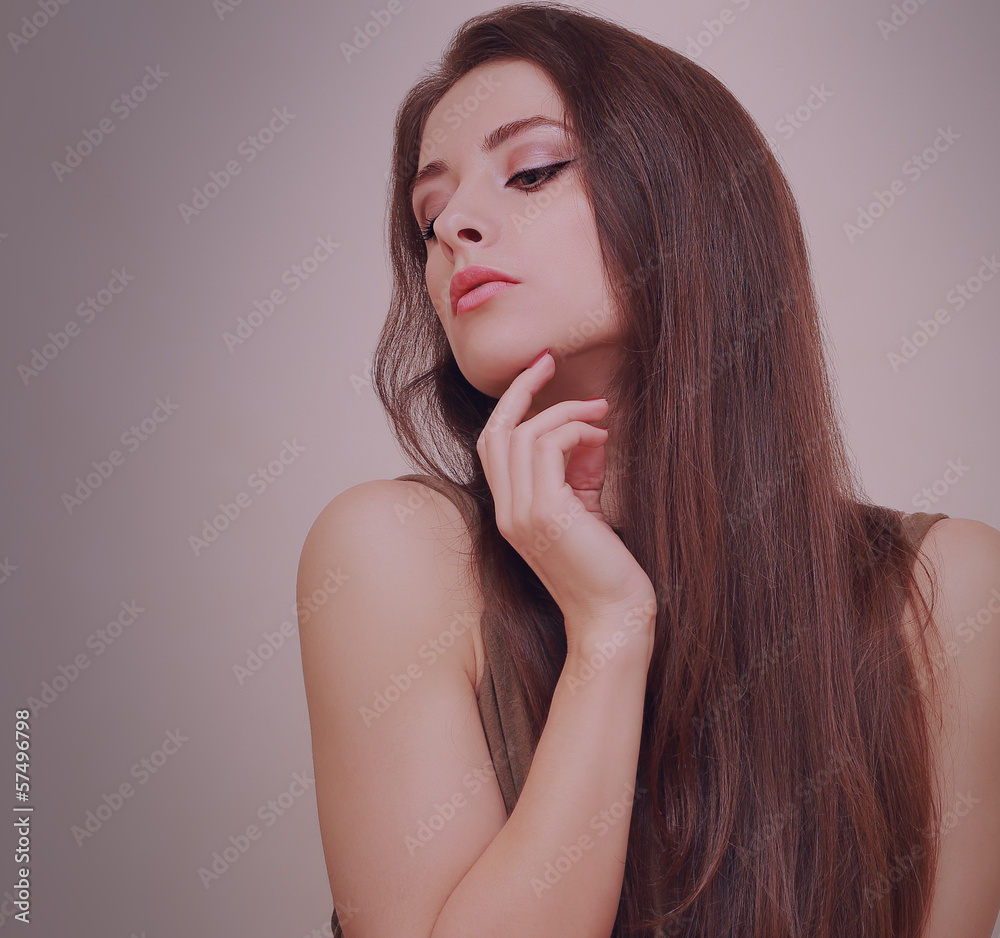 Sexy beautiful girl looking down with hand at face with long hai Stock