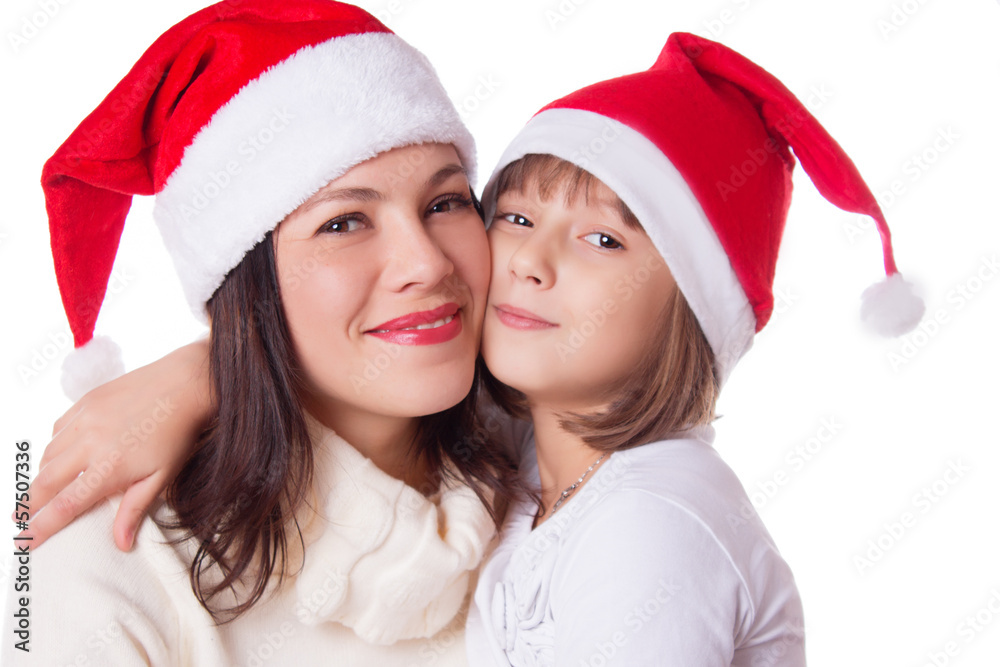 Happy mother and daughter hugging in Christmas hat Happy mother and daughter hugging in Christmas hat