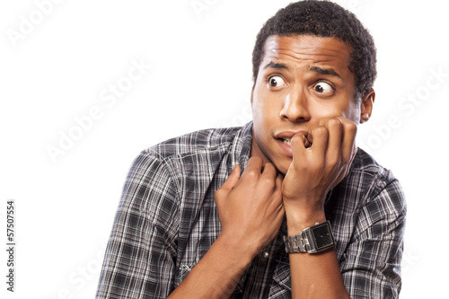 scared dark-skinned young man posing on white background photo