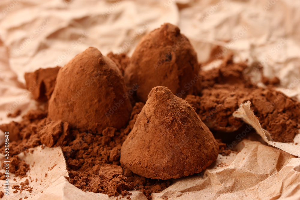 Chocolate truffles and cocoa, on brown background Chocolate truffles and cocoa, on brown background