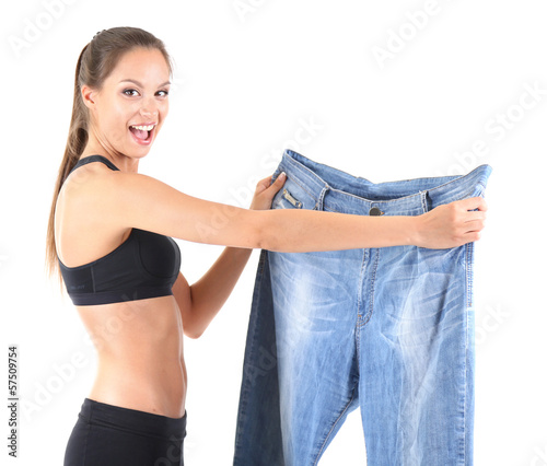 Slim girl with big jeans is...