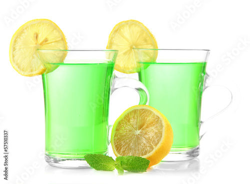 Two transparent cups of green tea with mint and lemon isolated