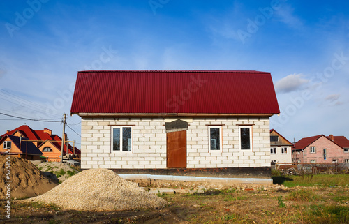 house under construction on background of sky