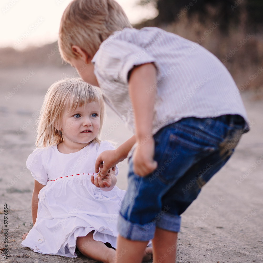 Fototapeta premium Preteen girl and boy holding their hands