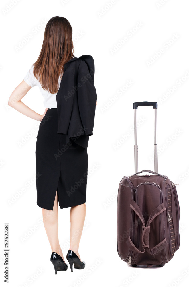 back view of thoughtful business woman traveling with suitcas. back view of thoughtful business woman traveling with suitcas.