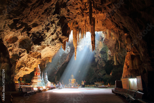golden Buddha in Thai cave photo