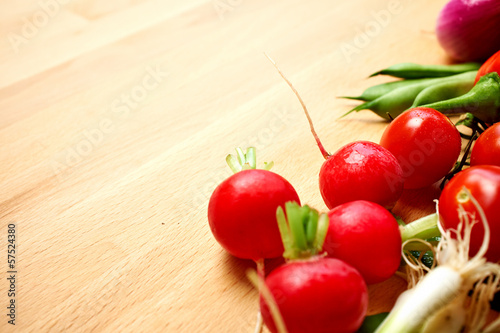 Bunch of fresh radishes on old wooden table
