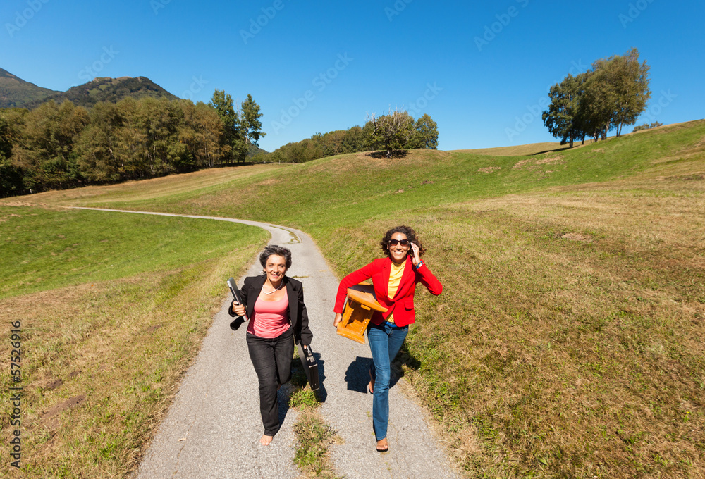 two business women in the countryside, outdoors