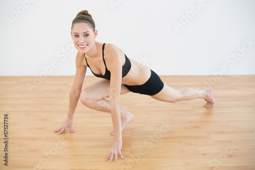 Portrait of sporty woman stretching her leg