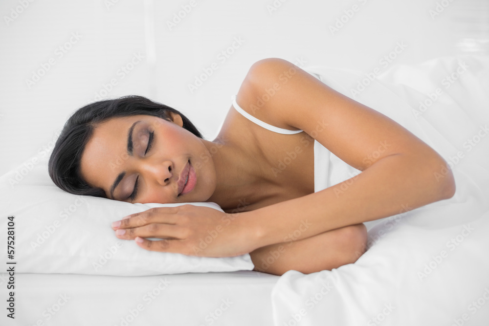 Content sleeping woman lying under the cover on her bed Content sleeping woman lying under the cover on her bed
