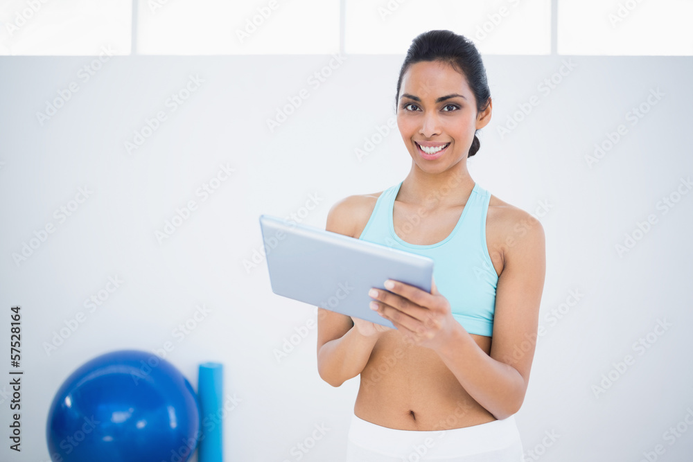 Content beautiful woman in sportswear holding her tablet Content beautiful woman in sportswear holding her tablet