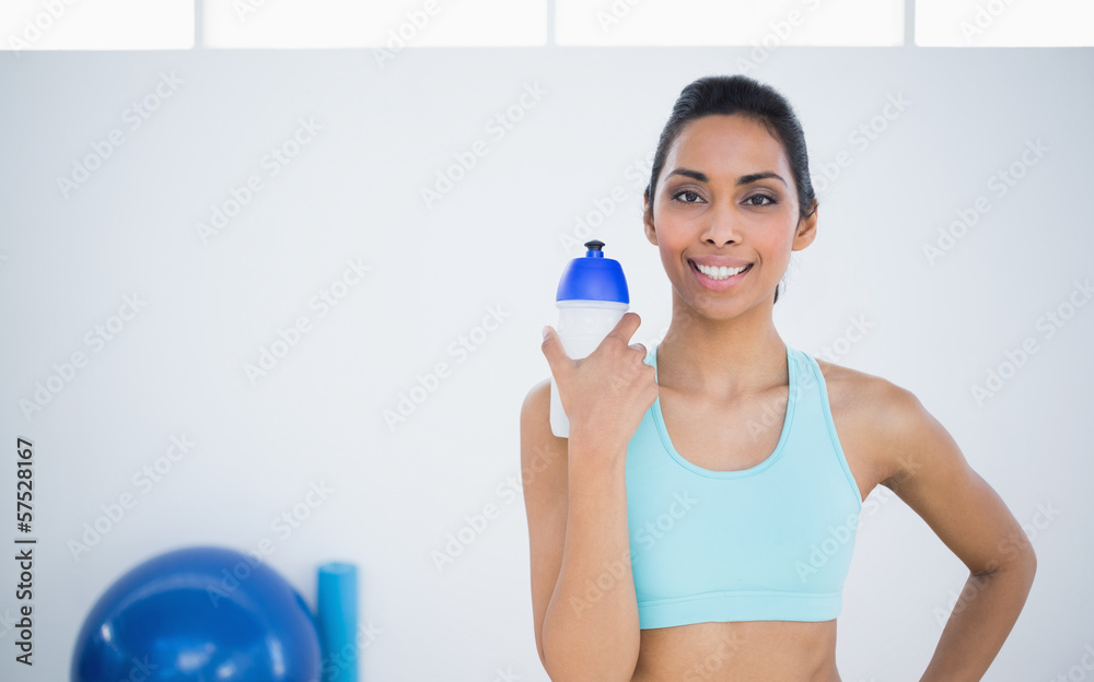 Sweet sporty woman posing holding sports bottle Sweet sporty woman posing holding sports bottle