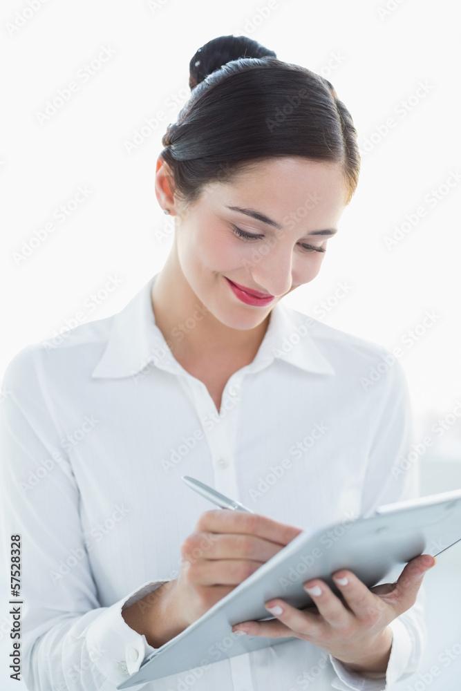 Smiling business woman with clipboard and pen Smiling business woman with clipboard and pen