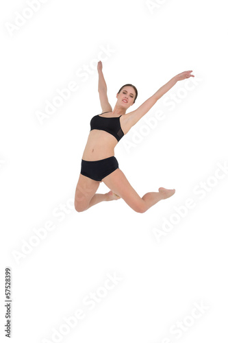Sporty woman jumping isolated on white background