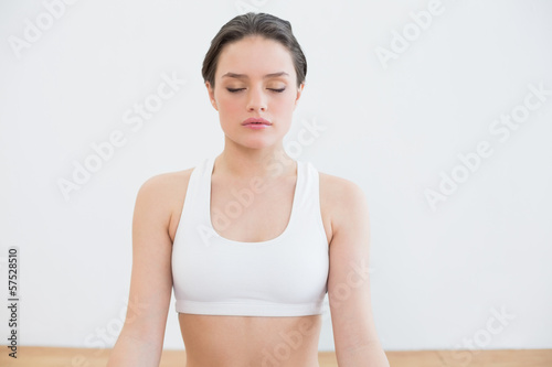 Obraz na plátně Woman with eyes closed at fitness studio