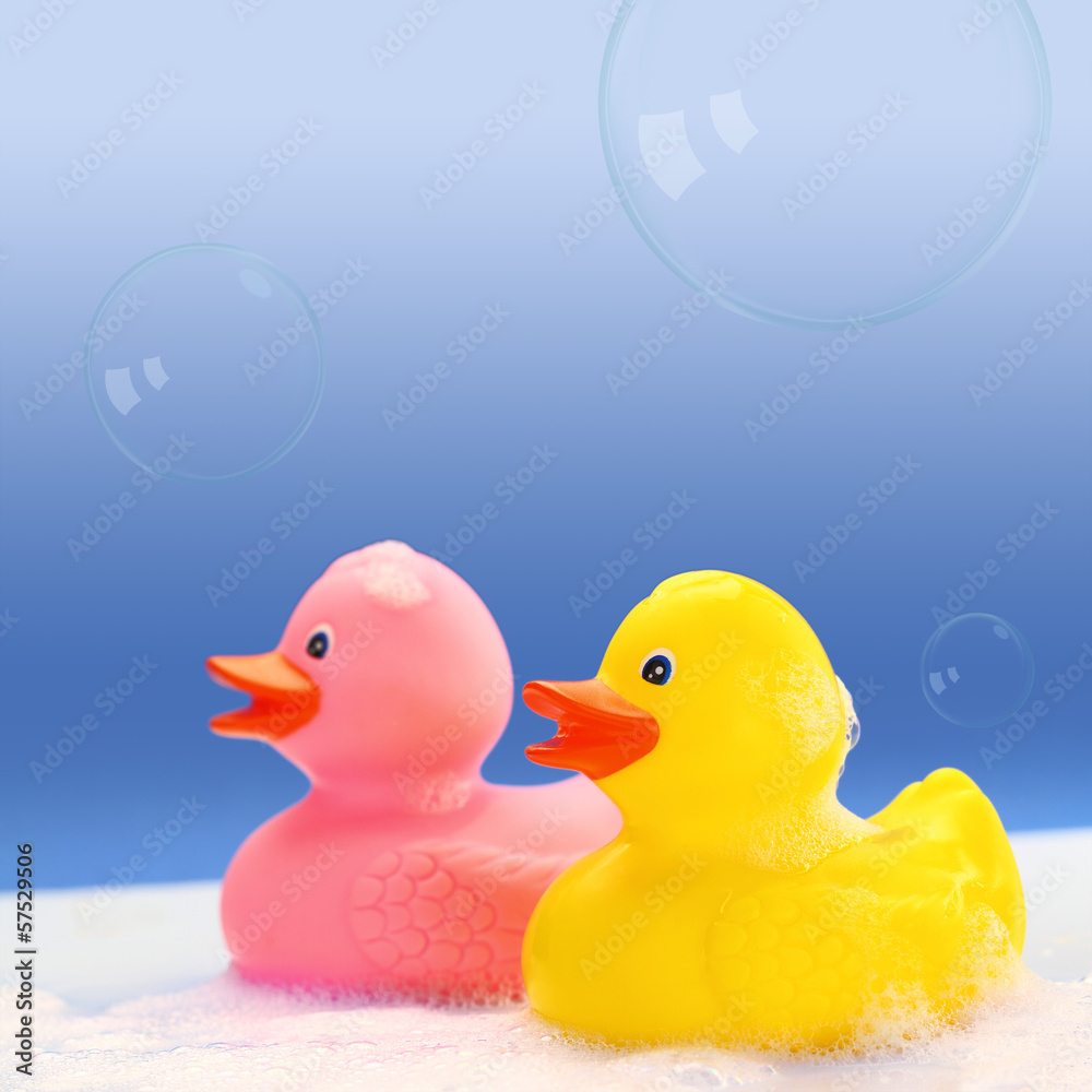 Yellow and pink rubber ducks in bath foam Yellow and pink rubber ducks in bath foam