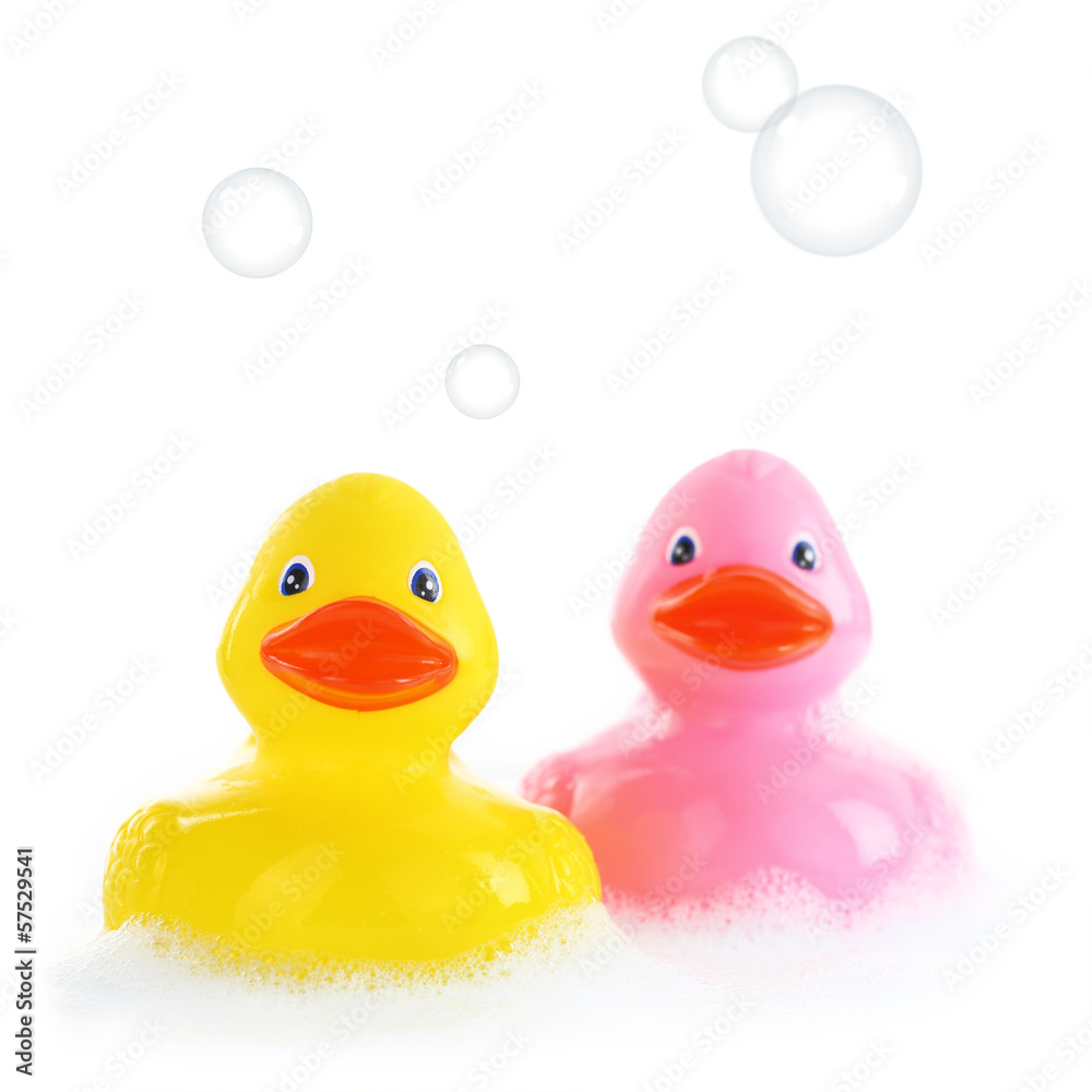 Yellow and pink rubber ducks in bath foam