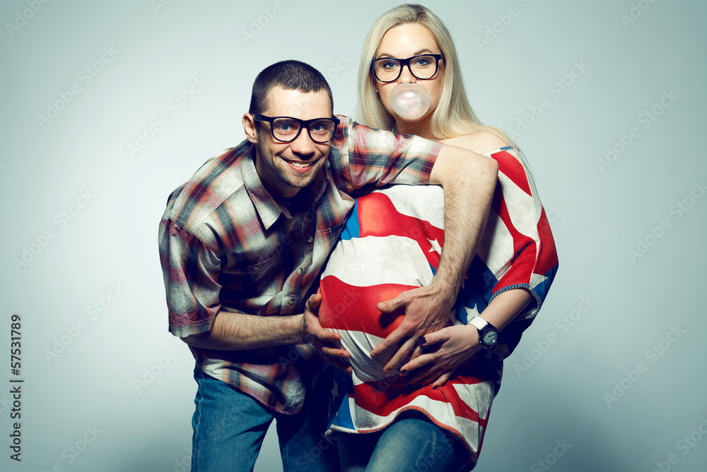 Obraz premium Happy american family (pregnancy) concept: two funny hipsters