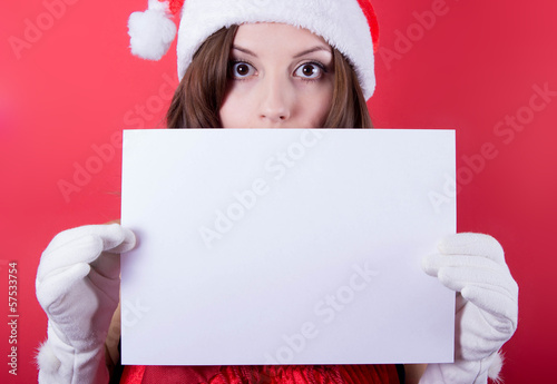 Christmas girl in santa hat holding banner. Isolated.