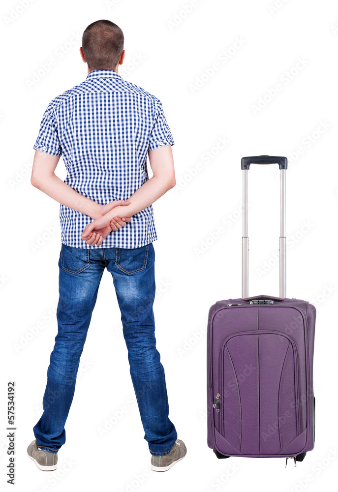 Back view of young man traveling with suitcas. Back view of young man traveling with suitcas.