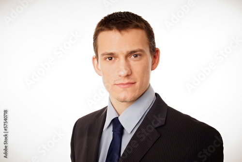 Portrait of young businessman at a suit with looking on you.