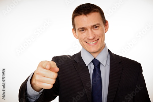 Young businessman at suit pointing at you.