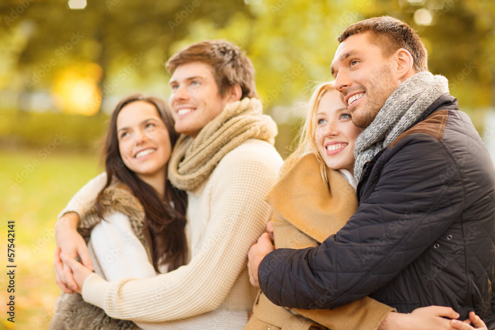 group of friends having fun in autumn park