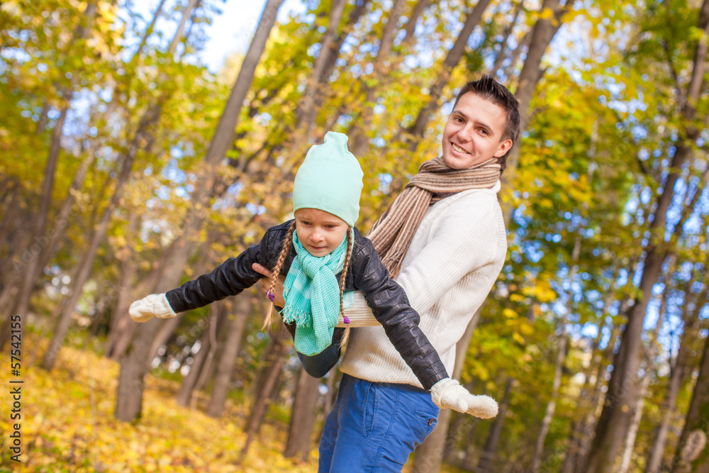 Little cute girl with happy father having fun in autumn park on Little cute girl with happy father having fun in autumn park on