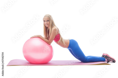 Lovely young blonde doing fitness in studio