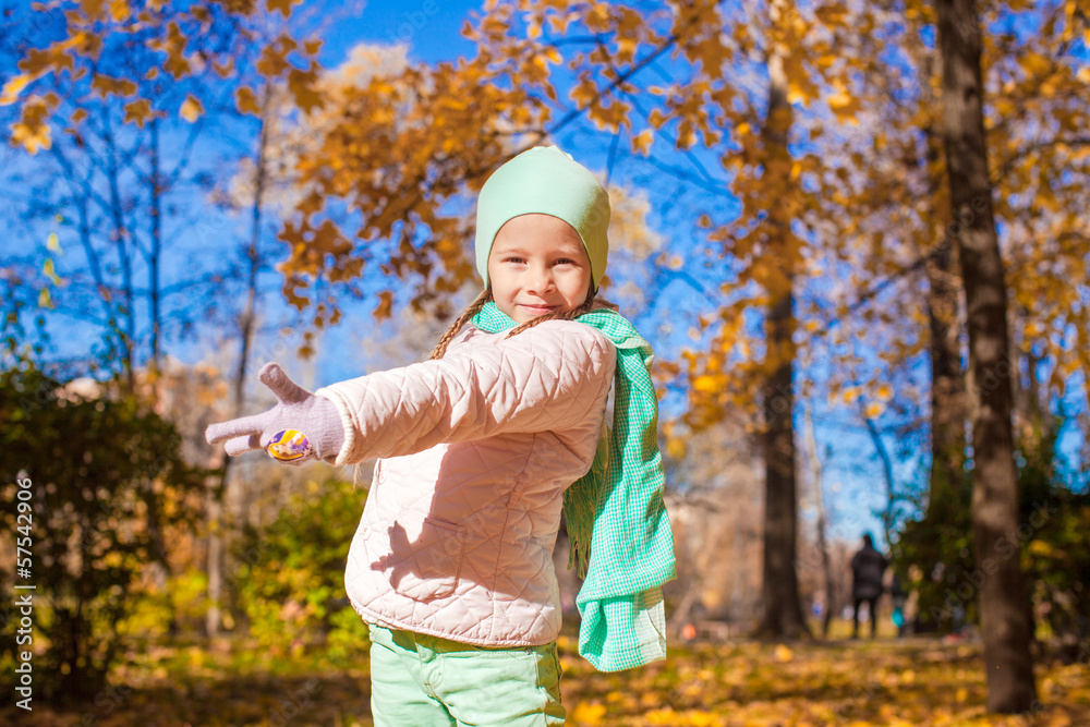 Little cute girl on the autumn meadow in a sunny fall day Little cute girl on the autumn meadow in a sunny fall day