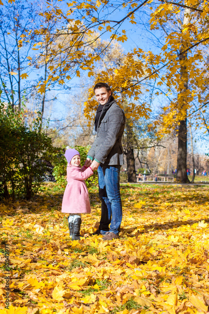 Young father and little girl enjoy vacation in autumn park Young father and little girl enjoy vacation in autumn park