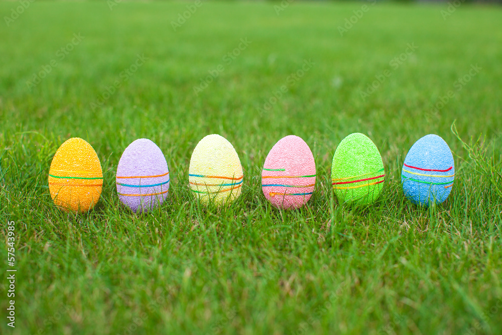 Colored colorful easter eggs in the grass