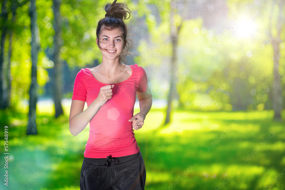 Runner - woman running outdoors in green park Runner - woman running outdoors in green park