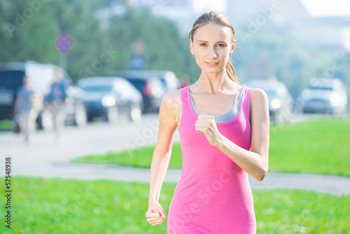 Jogging woman running in city park