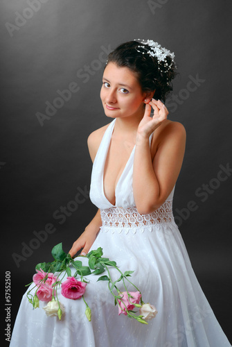 Fotografie Happy bride readjusting an earring